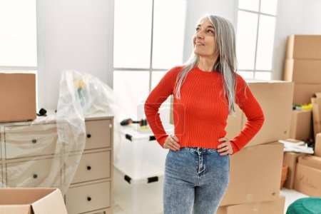 Photo for Middle age grey-haired woman smiling confident standing at new home - Royalty Free Image