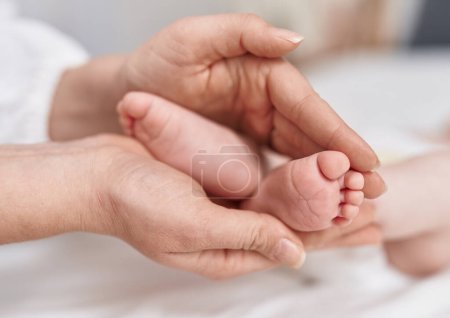 Photo for Adorable caucasian baby lying on bed having feet massage at bedroom - Royalty Free Image