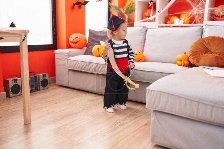 Photo for Adorable caucasian boy wearing pirate costume holding sword at home - Royalty Free Image