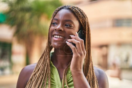 Photo for African american woman smiling confident talking on the smartphone at street - Royalty Free Image