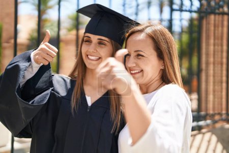 Photo for Two women mother and graduated daughter doing ok gesture at campus university - Royalty Free Image