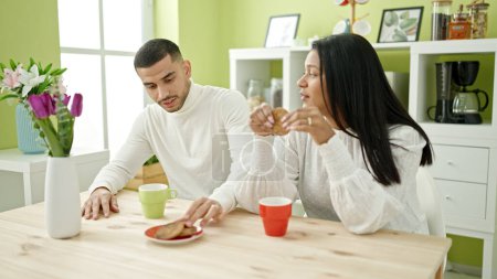 Photo for Man and woman couple having breakfast sitting on table at home - Royalty Free Image