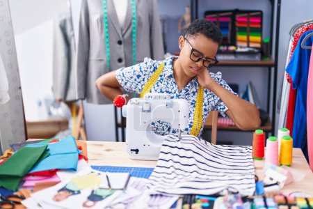 Photo for African american woman tailor stressed using sewing machine at tailor shop - Royalty Free Image