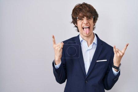 Photo for Hispanic business young man wearing glasses shouting with crazy expression doing rock symbol with hands up. music star. heavy music concept. - Royalty Free Image