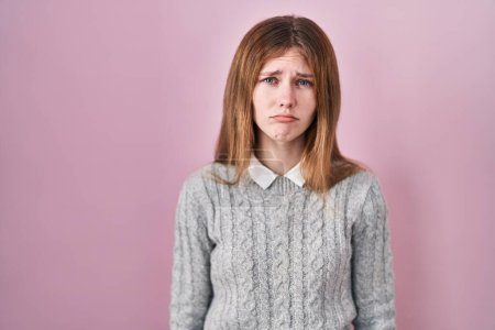 Photo for Beautiful woman standing over pink background depressed and worry for distress, crying angry and afraid. sad expression. - Royalty Free Image