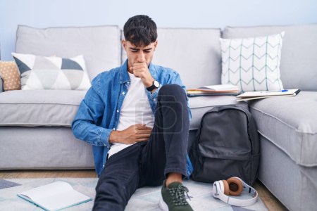 Photo for Young hispanic man sitting on the floor studying for university feeling unwell and coughing as symptom for cold or bronchitis. health care concept. - Royalty Free Image