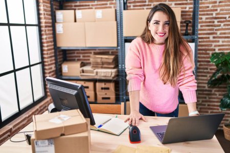 Photo for Young beautiful hispanic woman ecommerce business worker smiling confident standing at office - Royalty Free Image