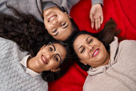 Photo for Three woman smiling confident lying on blanket at home - Royalty Free Image
