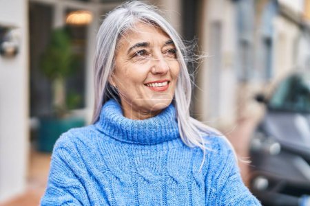 Photo for Middle age grey-haired woman smiling confident looking to the side at street - Royalty Free Image