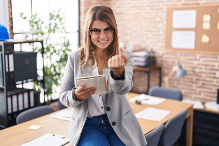 Photo for Young hispanic woman working at the office wearing glasses beckoning come here gesture with hand inviting welcoming happy and smiling - Royalty Free Image