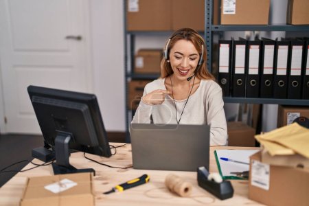 Photo for Hispanic woman working at small business ecommerce wearing headset pointing finger to one self smiling happy and proud - Royalty Free Image