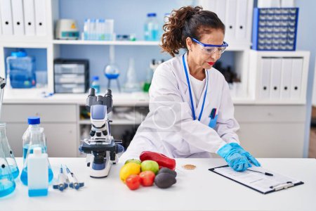 Photo for Middle age hispanic woman working at laboratory - Royalty Free Image