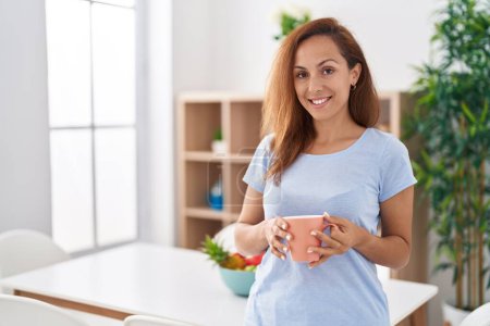 Photo for Young woman smiling confident drinking coffee at home - Royalty Free Image