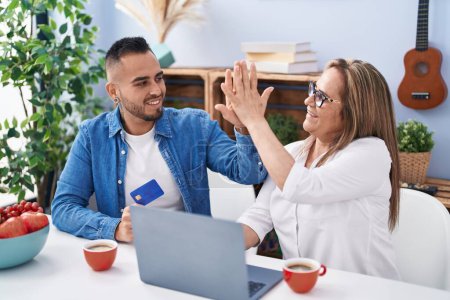 Photo for Man and woman mother and son high five with hands raised up at home - Royalty Free Image