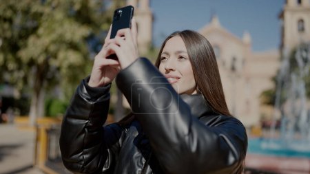 Photo for Young beautiful hispanic woman smiling confident making photo by the smartphone at park - Royalty Free Image