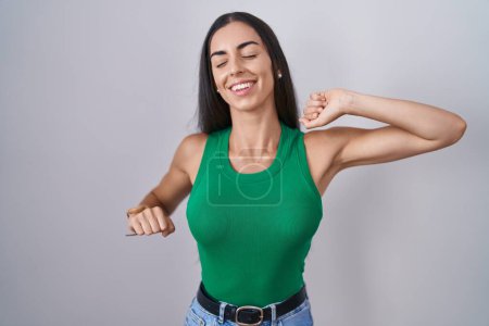 Photo for Young woman standing over isolated background stretching back, tired and relaxed, sleepy and yawning for early morning - Royalty Free Image