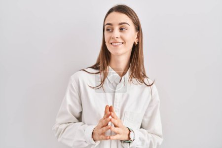 Photo for Young caucasian woman standing over isolated background hands together and fingers crossed smiling relaxed and cheerful. success and optimistic - Royalty Free Image