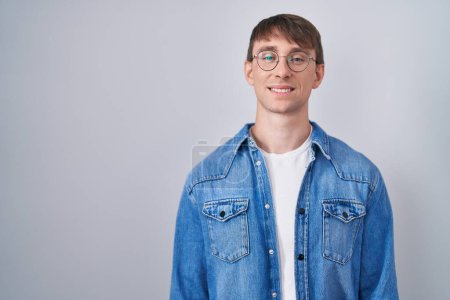 Photo for Caucasian blond man standing wearing glasses with a happy and cool smile on face. lucky person. - Royalty Free Image
