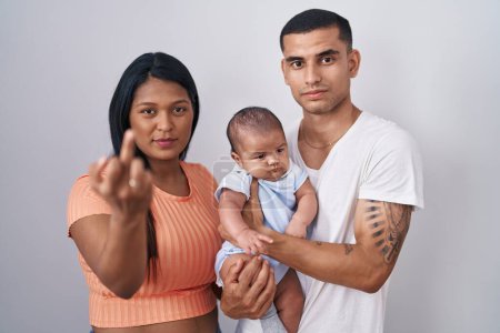 Téléchargez les photos : Young hispanic couple with baby standing together over isolated background showing middle finger, impolite and rude fuck off expression - en image libre de droit