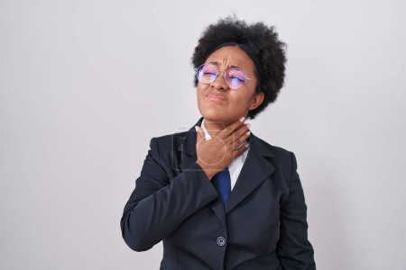 Photo for Beautiful african woman with curly hair wearing business jacket and glasses touching painful neck, sore throat for flu, clod and infection - Royalty Free Image