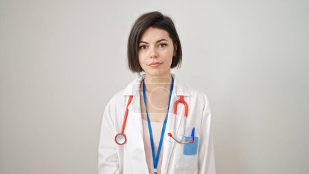 Photo for Young caucasian woman doctor standing with serious expression over isolated white background - Royalty Free Image