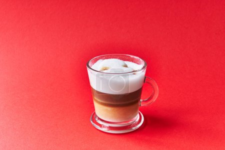 Photo for One cup of cappuccino coffee over red background - Royalty Free Image