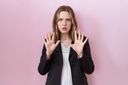 Photo for Young caucasian business woman wearing black jacket moving away hands palms showing refusal and denial with afraid and disgusting expression. stop and forbidden. - Royalty Free Image