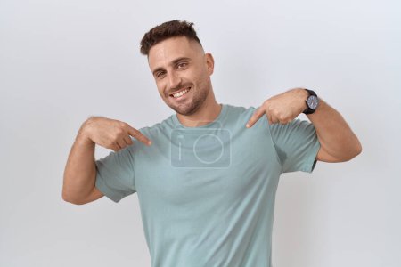 Photo for Hispanic man with beard standing over white background looking confident with smile on face, pointing oneself with fingers proud and happy. - Royalty Free Image