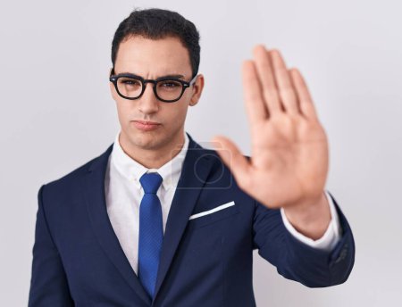Photo for Young hispanic man wearing suit and tie doing stop sing with palm of the hand. warning expression with negative and serious gesture on the face. - Royalty Free Image