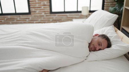 Téléchargez les photos : Jeune homme caucasien couché sur le lit dormant dans la chambre - en image libre de droit