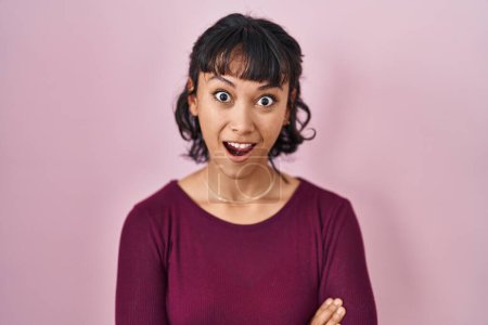 Photo for Young beautiful woman standing over pink background afraid and shocked with surprise expression, fear and excited face. - Royalty Free Image