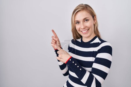 Photo for Young caucasian woman wearing casual navy sweater smiling and looking at the camera pointing with two hands and fingers to the side. - Royalty Free Image