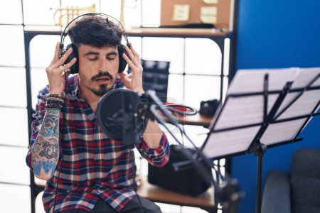 Photo for Young hispanic man artist singing song at music studio - Royalty Free Image