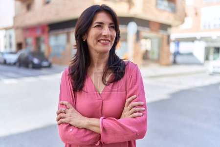 Photo for Middle age hispanic woman standing with arms crossed gesture at street - Royalty Free Image