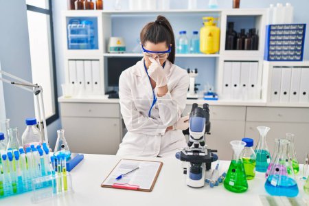 Photo for Young beautiful hispanic woman scientist stressed working at laboratory - Royalty Free Image