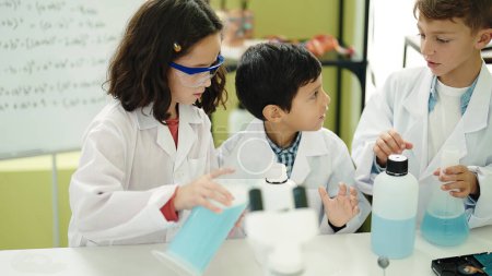 Photo for Group of kids students pouring liquid on bottl doing experiment at laboratory classroom - Royalty Free Image