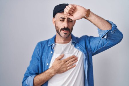 Photo for Hispanic man with beard standing over isolated background touching forehead for illness and fever, flu and cold, virus sick - Royalty Free Image