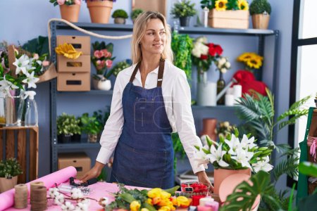 Photo for Young blonde woman florist smiling confident standing at florist - Royalty Free Image