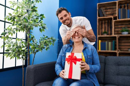 Photo for Mother and son surprise with birthday gift at home - Royalty Free Image