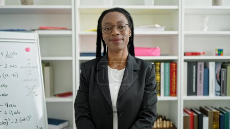 Photo for African american woman teacher smiling confident standing at university classroom - Royalty Free Image