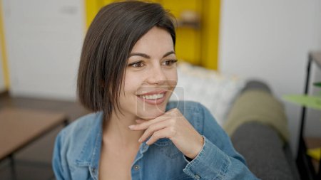 Foto de Young caucasian woman smiling confident sitting on sofa at home - Imagen libre de derechos