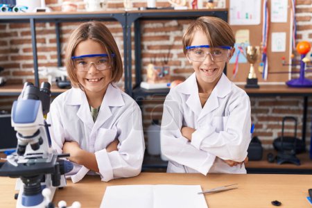 Photo for Adorable boys students standing with arms crossed gesture at laboratory classroom - Royalty Free Image