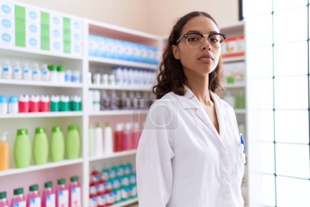 Photo for Young african american woman pharmacist standing with relaxed expression at pharmacy - Royalty Free Image
