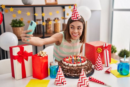 Photo for Young beautiful hispanic woman celebrating birthday make selfie by smartphone at home - Royalty Free Image