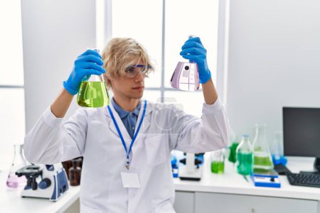 Photo for Young blond man scientist holding test tubes at laboratory - Royalty Free Image