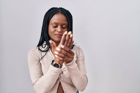 Photo for African woman with braids standing over white background suffering pain on hands and fingers, arthritis inflammation - Royalty Free Image
