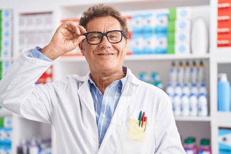 Photo for Middle age man pharmacist smiling confident at pharmacy - Royalty Free Image