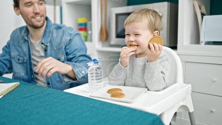 Photo for Father and son working and taking care child at dinning room - Royalty Free Image