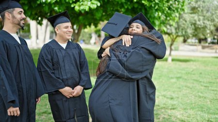 Photo for Group of people students graduated smiling confident hugging each other at university campus - Royalty Free Image