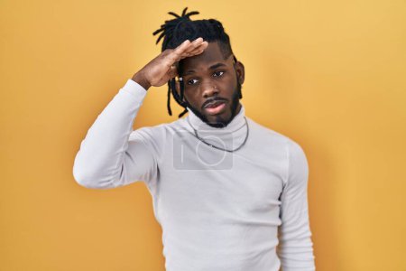 Photo for African man with dreadlocks wearing turtleneck sweater over yellow background worried and stressed about a problem with hand on forehead, nervous and anxious for crisis - Royalty Free Image